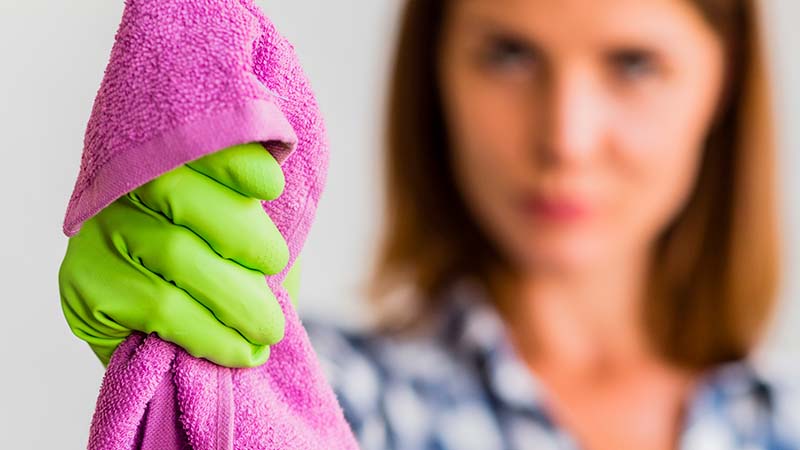 A woman holding a pink twisted loop microfiber towel