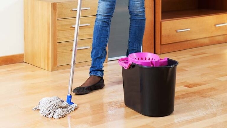 A woman using a Cotton loop-end mop