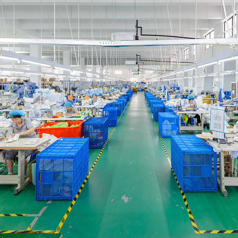 A group of employees diligently sewing microfiber mop heads