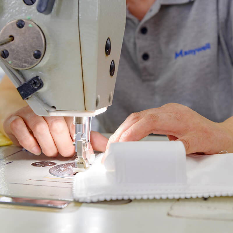 Employees sewing microfiber mops