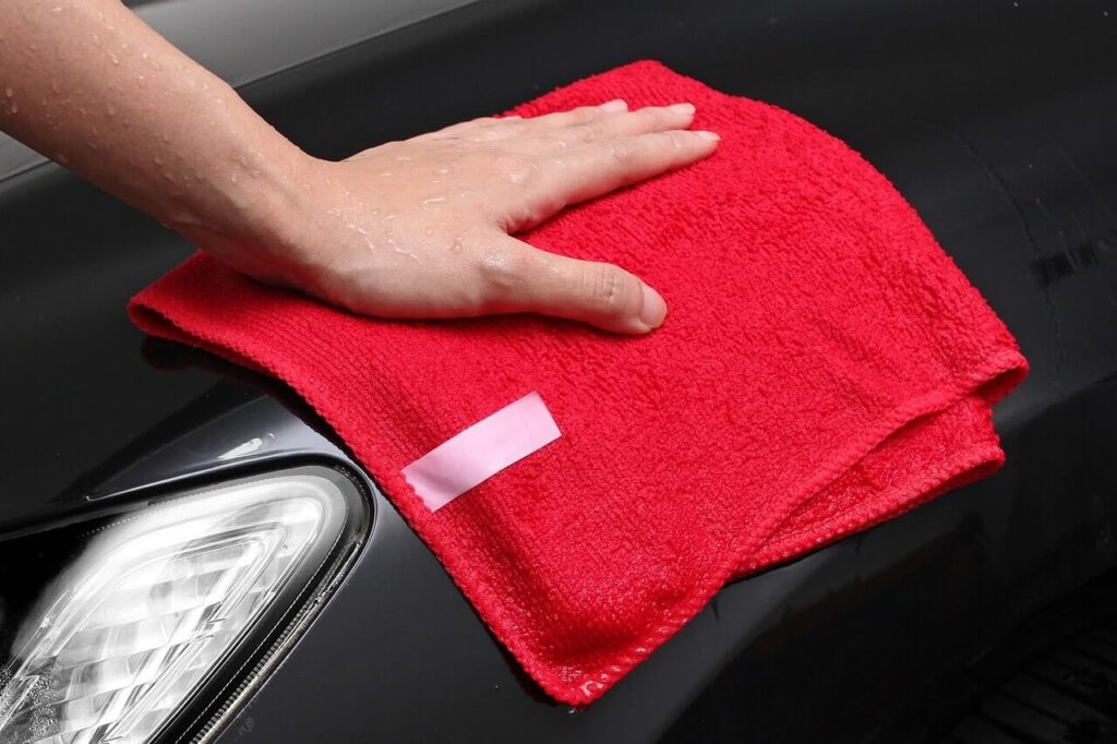 Red microfiber cloth on a car