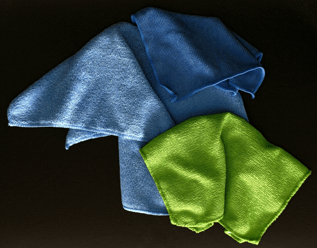 Three pieces of microfiber cloths, light blue, blue, and lime.